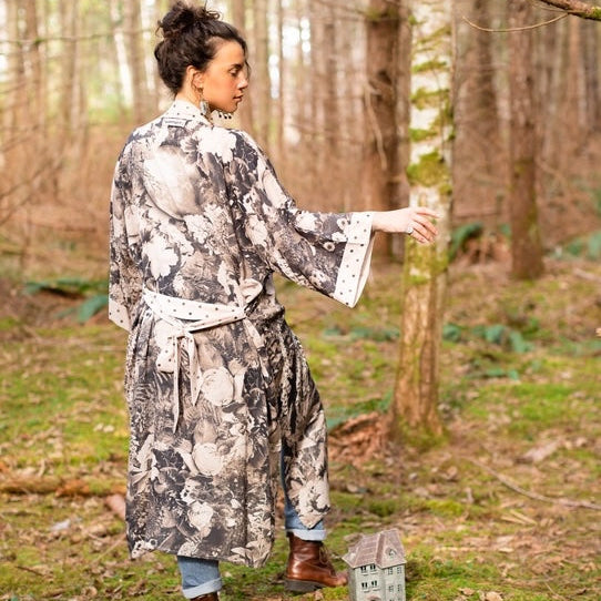 Woman in a grey and white botanical print kimono robe standing in a pine forest – Market of Stars