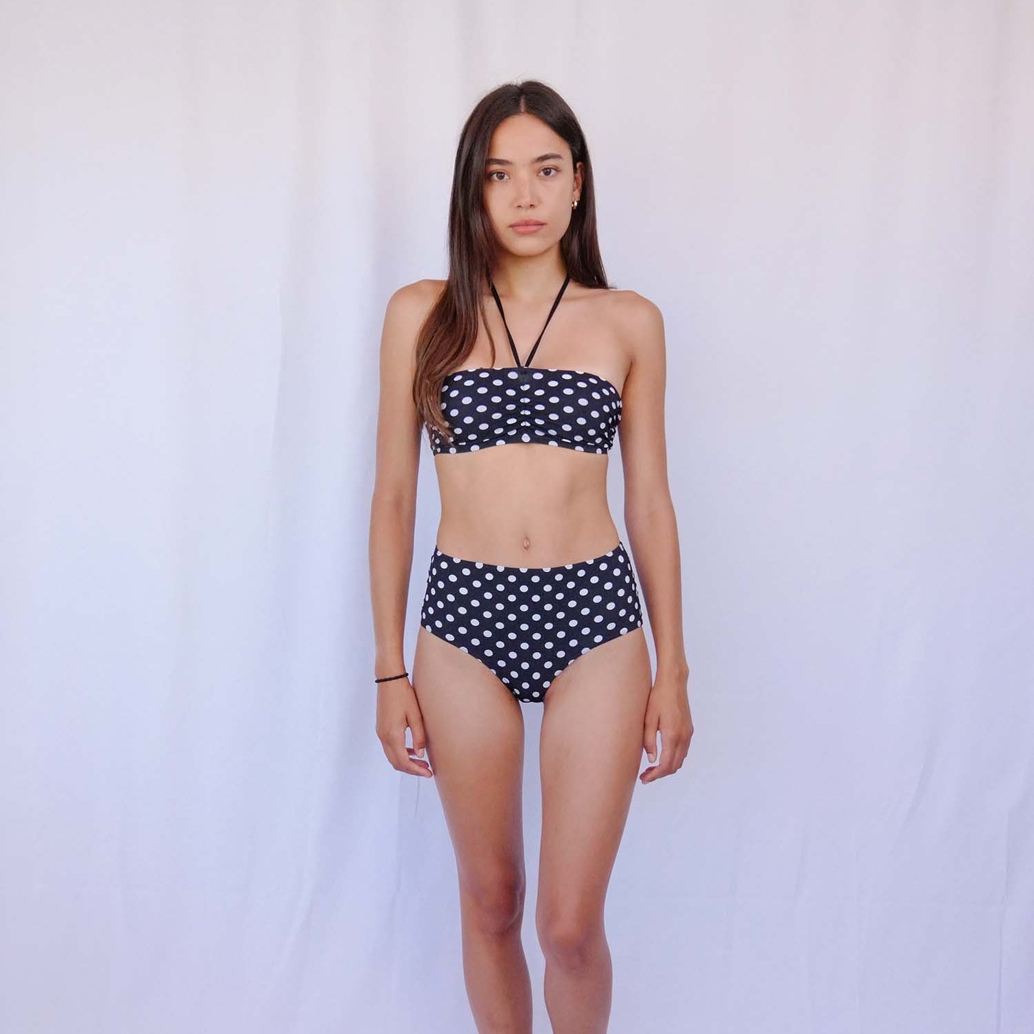 Model wearing the polka-dot high-waist bikini in full sunlight – Blanche Edit
